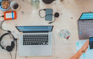 Computers on Desk with Person on Phone