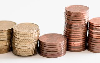 Gold and Copper Coins Stacked in uneven amounts