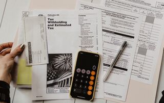Sitting on Floor with Tax Planning Materials