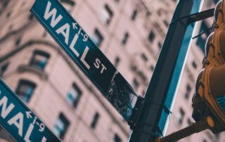 Wall Street, Street Signs and Stoplight with buildings in backgound