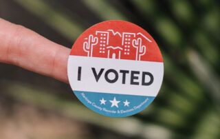 I voted sticker on finger with greenery background