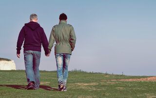 Couple Walking By Ocean