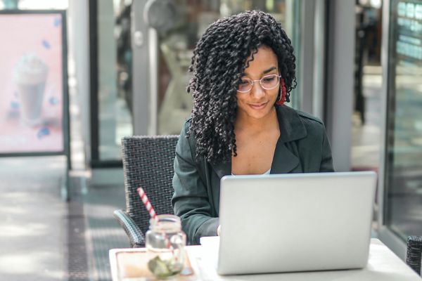 Woman Using a Computer at a Cafe