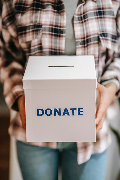 Person Holding Donation Box