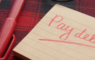 Pay Debt On Post-it with Red Pen