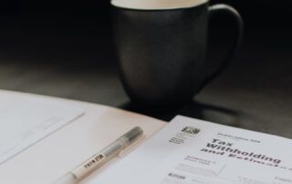 Coffee Cup and Tax Documents