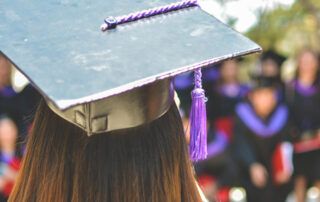 Graduating Student with Grad Cap and Audience