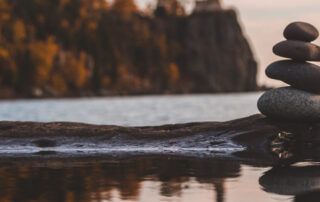 Stacked Rocks with Reflection in Lake During Fall