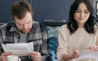 Couple Reviewing Documents at Desk