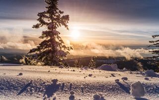 Sunrise Over Snowy Hillside