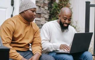 Parent & Teen on Computer Outside