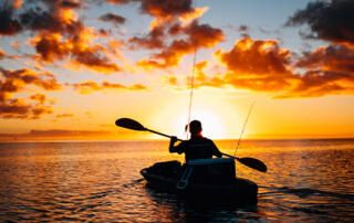 Kayaking on Lake During Sunrise