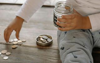 Child with Jar and Coins