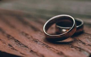 Wedding Bands On Wooden Table