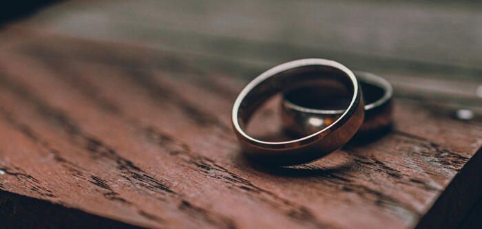 Wedding Bands On Wooden Table