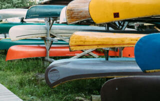 Stacked Canoes During Summer Day