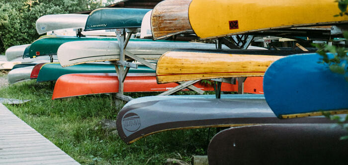 Stacked Canoes During Summer Day